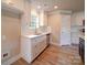 Bright kitchen with white cabinets, quartz countertops, stainless steel appliances, and modern fixtures at 1133 Heather Oak Ln, Oakboro, NC 28129