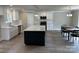 Modern kitchen with stainless appliances, white cabinets, large island, and an adjacent dining area at 1133 Heather Oak Ln, Oakboro, NC 28129