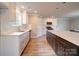 Bright eat-in kitchen with white cabinets, light countertops, stainless appliances, and a large center island at 1133 Heather Oak Ln, Oakboro, NC 28129