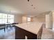 Open floorplan with island and seating flowing to table and living spaces at 1133 Heather Oak Ln, Oakboro, NC 28129