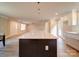 A kitchen island faces open living spaces, featuring modern cabinetry and quartz countertops at 1133 Heather Oak Ln, Oakboro, NC 28129