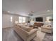 Open concept living room with light colored sofas and rug at 1133 Heather Oak Ln, Oakboro, NC 28129