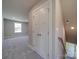 Upstairs hallway with carpet, doors to bedrooms, and a window at 1133 Heather Oak Ln, Oakboro, NC 28129