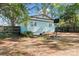 Backyard view of charming light blue home featuring a basketball court at 209 21St St, Newton, NC 28658