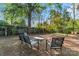 Outdoor patio with chairs and table set, fenced in yard, mature trees, and swing set at 209 21St St, Newton, NC 28658