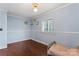 Light blue bedroom with hardwood floors, bright natural light, and playful cartoon decor at 209 21St St, Newton, NC 28658