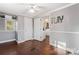 Comfortable bedroom with a ceiling fan, hardwood floors, and plenty of natural light at 209 21St St, Newton, NC 28658
