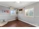 Cozy bedroom with warm hardwood floors, two windows and playful decor at 209 21St St, Newton, NC 28658