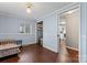 Cozy bedroom featuring hardwood floors, a window, and access to the kitchen at 209 21St St, Newton, NC 28658