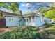 Charming home showcasing light blue siding, green landscaping, and inviting pathway to the front door at 209 21St St, Newton, NC 28658