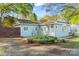 Charming single-story home featuring light blue siding, well-manicured landscaping, and welcoming front entrance at 209 21St St, Newton, NC 28658