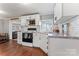 Well-lit kitchen features white cabinets, black appliances, and a window providing natural light at 209 21St St, Newton, NC 28658