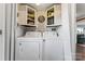 Functional laundry room with a washer, dryer, upper cabinets and great storage solutions at 209 21St St, Newton, NC 28658