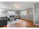 Bright living room featuring hardwood floors, gray sofa, and natural light at 209 21St St, Newton, NC 28658