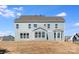 This is a view of the back of the house with lots of windows and a spacious yard at 5703 Allburn Pkwy, Concord, NC 28027