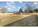 Fenced backyard featuring an outbuilding and large trees scattered throughout the yard at 1007 Ashford St, Charlotte, NC 28214