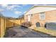 Backyard brick home featuring wood privacy fence, patio area and an air conditioner unit at 1007 Ashford St, Charlotte, NC 28214