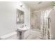 Clean bathroom with modern vanity, bathtub and shower with attractive tile surround at 1007 Ashford St, Charlotte, NC 28214