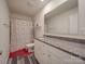 Bright bathroom with granite counters, white cabinets, and modern fixtures at 8932 Myra Way, Charlotte, NC 28215