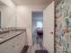 Hall bathroom leading to bedroom with granite countertop and decorative shower curtain at 8932 Myra Way, Charlotte, NC 28215