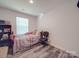 Bedroom with luxury vinyl plank flooring and natural light at 8932 Myra Way, Charlotte, NC 28215