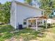 Backyard view of the home with a covered patio area, grill, and outdoor seating at 8932 Myra Way, Charlotte, NC 28215