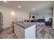 Kitchen island featuring granite countertops overlooks the living area at 8932 Myra Way, Charlotte, NC 28215