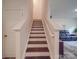 Stairway featuring wood steps and white painted risers and rails at 8932 Myra Way, Charlotte, NC 28215