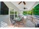 Cozy screened-in porch with ceiling fans, a TV, and a dining set for outdoor relaxation at 423 Old Dutch Rd, Indian Trail, NC 28079