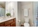 Bright bathroom features a vanity with a mirror, tiled floors, and a shower with curtain at 423 Old Dutch Rd, Indian Trail, NC 28079