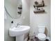 Well-lit half bath with a pedestal sink, stylish fixtures, and rustic decor at 423 Old Dutch Rd, Indian Trail, NC 28079