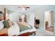 Cozy bedroom featuring a four-poster bed, ceiling fan, and doorway leading to bathroom at 423 Old Dutch Rd, Indian Trail, NC 28079