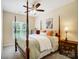 Bright bedroom featuring natural light, ceiling fan, and four poster bed with accent pillows at 423 Old Dutch Rd, Indian Trail, NC 28079