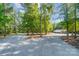 Wide gravel driveway surrounded by lush trees leading to an outbuilding at 423 Old Dutch Rd, Indian Trail, NC 28079