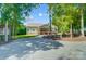 A quaint home exterior featuring a spacious yard, gravel driveway, and charming outdoor space at 423 Old Dutch Rd, Indian Trail, NC 28079