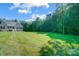 Spacious front lawn with home tucked away in the trees at 423 Old Dutch Rd, Indian Trail, NC 28079