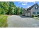 A long gravel driveway leads to an attached three car garage at 423 Old Dutch Rd, Indian Trail, NC 28079