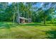 A sprawling lawn leads to the outbuilding, surrounded by shady trees at 423 Old Dutch Rd, Indian Trail, NC 28079