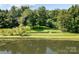 Peaceful waterfront property with lush green landscaping at 721 Orphanage Rd, Concord, NC 28027