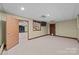 Basement room with an open door revealing access to other areas and a pet door at 721 Orphanage Rd, Concord, NC 28027