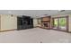 Basement recreation room featuring a brick fireplace, built-in shelving, and access to a patio at 721 Orphanage Rd, Concord, NC 28027