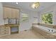 Luxurious bathroom with soaking tub, vanity, and large window at 721 Orphanage Rd, Concord, NC 28027