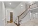 Elegant two-story entryway with hardwood floors and a grand staircase at 721 Orphanage Rd, Concord, NC 28027