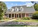 Spacious brick home with a large front porch and mature trees at 721 Orphanage Rd, Concord, NC 28027