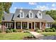 Brick home with a classic design, landscaping, and walkway at 721 Orphanage Rd, Concord, NC 28027