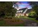 Brick home with a welcoming front porch, landscaping, and a long driveway at 721 Orphanage Rd, Concord, NC 28027