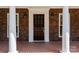 Elegant front door entrance with brick facade and white columns at 721 Orphanage Rd, Concord, NC 28027