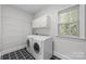 Laundry room with washer, dryer, and additional shelving at 721 Orphanage Rd, Concord, NC 28027