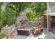 Cozy stone patio fireplace with seating area, perfect for outdoor entertaining at 721 Orphanage Rd, Concord, NC 28027