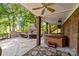 Outdoor patio with stone fireplace, hot tub, and seating at 721 Orphanage Rd, Concord, NC 28027